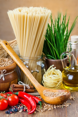 The composition of the pasta and vegetables on background の写真素材