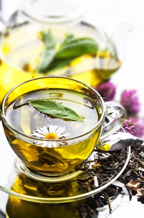 Cup with green tea and green leaves の写真素材