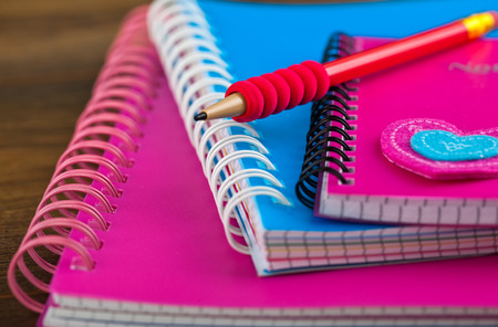 Back to school blackboard with pencilbox and school equipment on tableの写真素材
