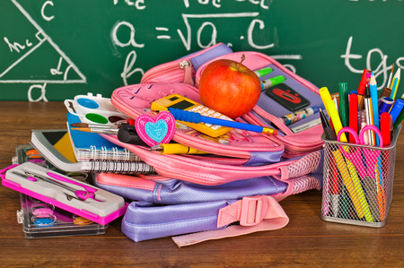 Back to school blackboard with pencilbox and school equipment on tableの写真素材