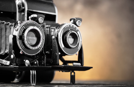 Old camera on an old background on a close-up tableの写真素材