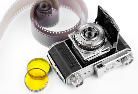 Old camera on white background on a close-up tableの写真素材