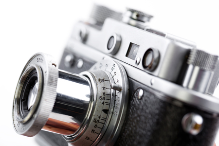 Old camera on white background on a close-up tableの写真素材