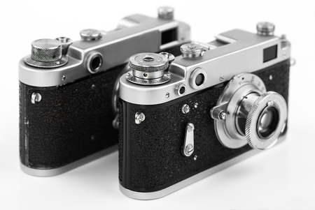 Old camera on white background on a close-up tableの写真素材