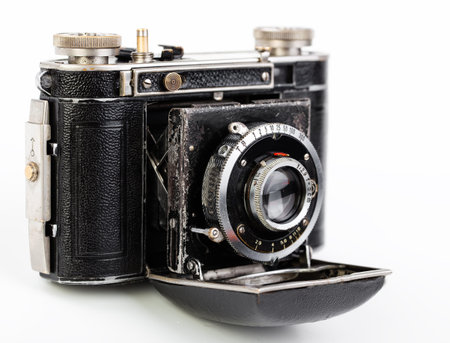 Old photo camera on white background, on the table, closeup