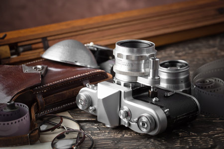 Old camera on a desk on an old background, closeup
