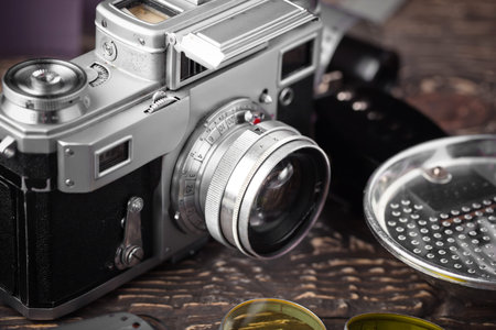 Old camera on a desk on an old background, closeup