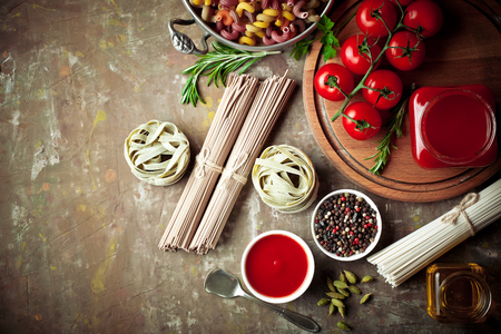 Raw pasta on the table in the composition with accessories for the kitchenの写真素材