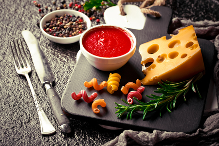 Raw pasta on the table in the composition with accessories for the kitchenの写真素材