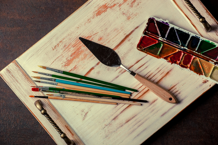 Paints for drawing and brush on a background in a compositionの写真素材