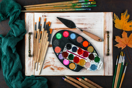 Paints for drawing and brush on a background in a compositionの写真素材