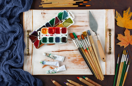 Paints for drawing and brush on a background in a compositionの写真素材