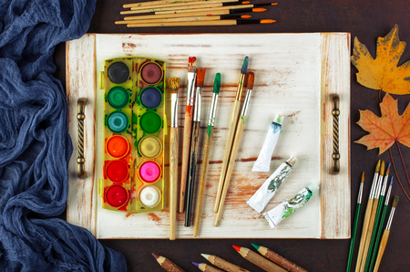 Paints for drawing and brush on a background in a compositionの写真素材