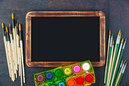Paints for drawing and brush on a background in a compositionの写真素材