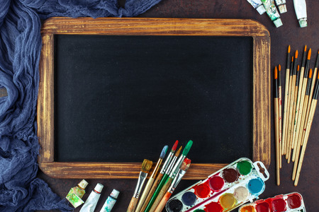 Paints for drawing and brush on a background in a compositionの写真素材