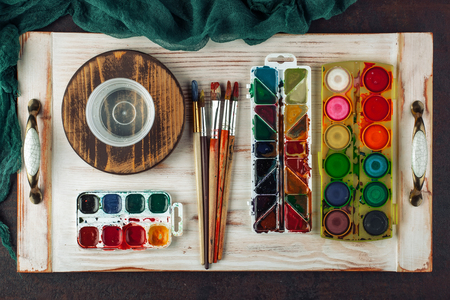 Paints for drawing and brush on a background in a compositionの写真素材