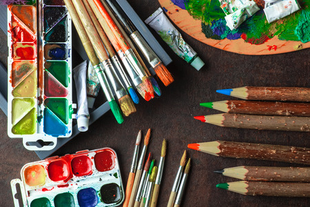 Paints for drawing and brush on a background in a compositionの写真素材