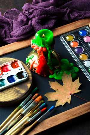 Paints for drawing and brush on a background in a compositionの写真素材