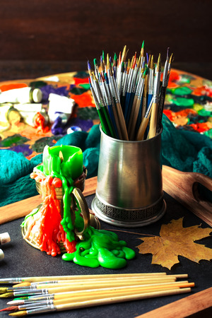 Paints for drawing and brush on a background in a compositionの写真素材