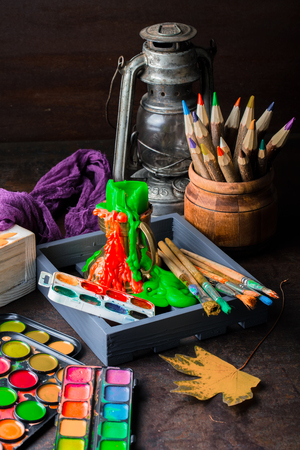 Paints for drawing and brush on a background in a compositionの写真素材