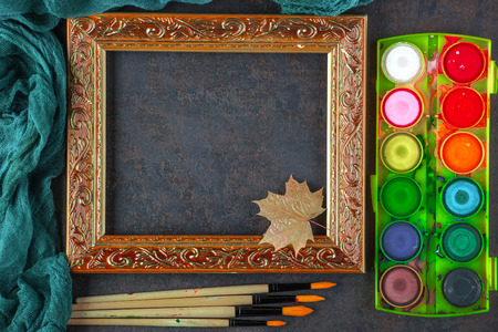 Paints for drawing and brush on a background in a compositionの写真素材