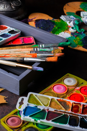 Paints for drawing and brush on a background in a compositionの写真素材