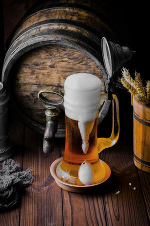 Light foam beer in a glass on an old backgroundの写真素材