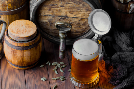 Light foam beer in a glass on an old backgroundの写真素材