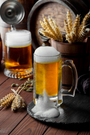 Light foam beer in a glass on an old backgroundの写真素材