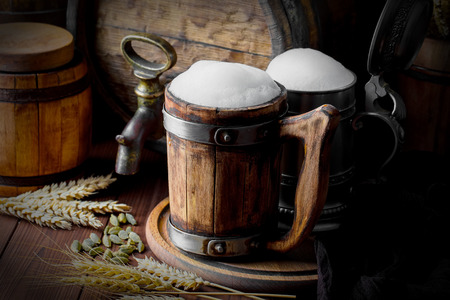 Light foam beer in a glass on an old backgroundの写真素材