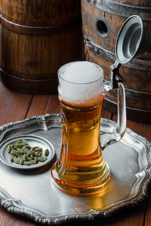 Light foam beer in a glass on an old backgroundの写真素材