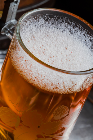 Light foam beer in a glass on an old backgroundの写真素材