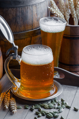 Light foam beer in a glass on an old backgroundの写真素材