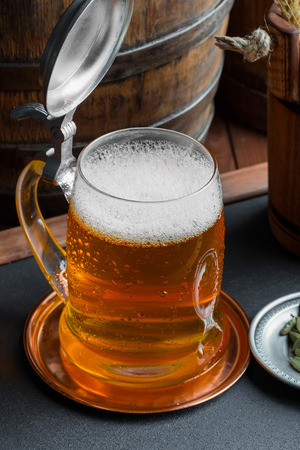Light foam beer in a glass on an old backgroundの写真素材