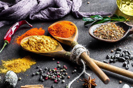 Spices for cooking with kitchen accessories on an old backgroundの写真素材