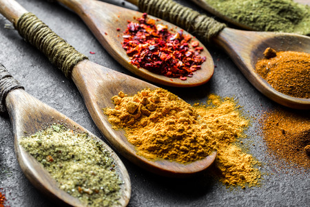 Spices for cooking with kitchen accessories on an old backgroundの写真素材