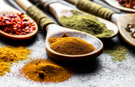 Spices for cooking with kitchen accessories on an old backgroundの写真素材