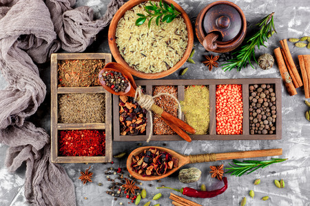 Spices for cooking with kitchen accessories on an old backgroundの写真素材