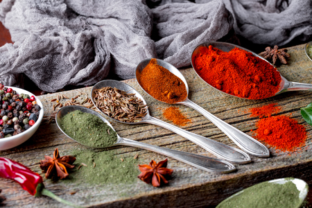 Spices for cooking with kitchen accessories on an old backgroundの写真素材