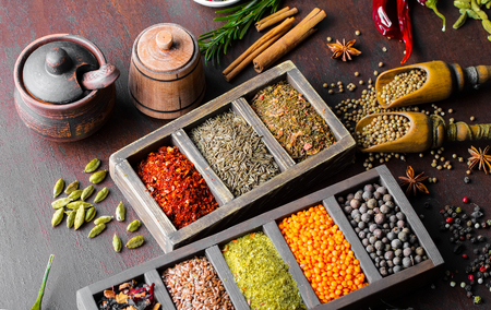 Spices for cooking with kitchen accessories on an old backgroundの写真素材