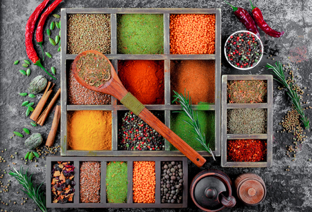 Spices for cooking with kitchen accessories on an old backgroundの写真素材