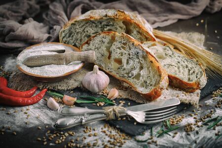Bread in the composition with kitchen accessories on the tableの写真素材