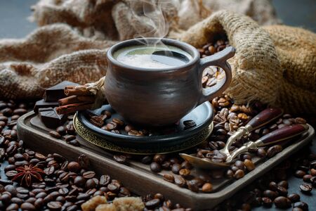 Coffee in a cup and saucer on an old background.の写真素材