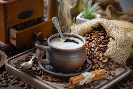 Coffee in a cup and saucer on the tableの写真素材