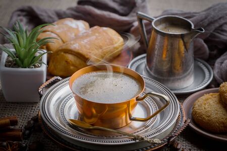 Coffee in a cup and saucer on an old background.の写真素材