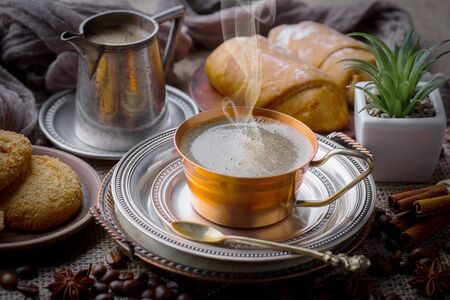 Coffee in a cup and saucer on an old background.の写真素材