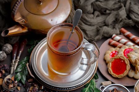 Tea hot drink on old background in composition on the tableの写真素材