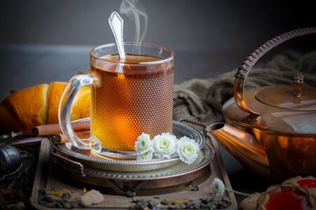 Tea hot drink on old background in composition on the tableの写真素材