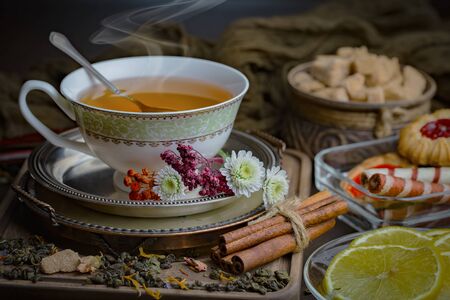 Tea hot drink on old background in composition on the tableの写真素材