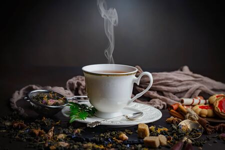 Tea hot drink on old background in composition on the tableの写真素材